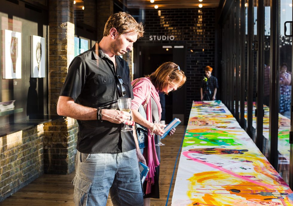 Visitors to Fertility Fest looking at art